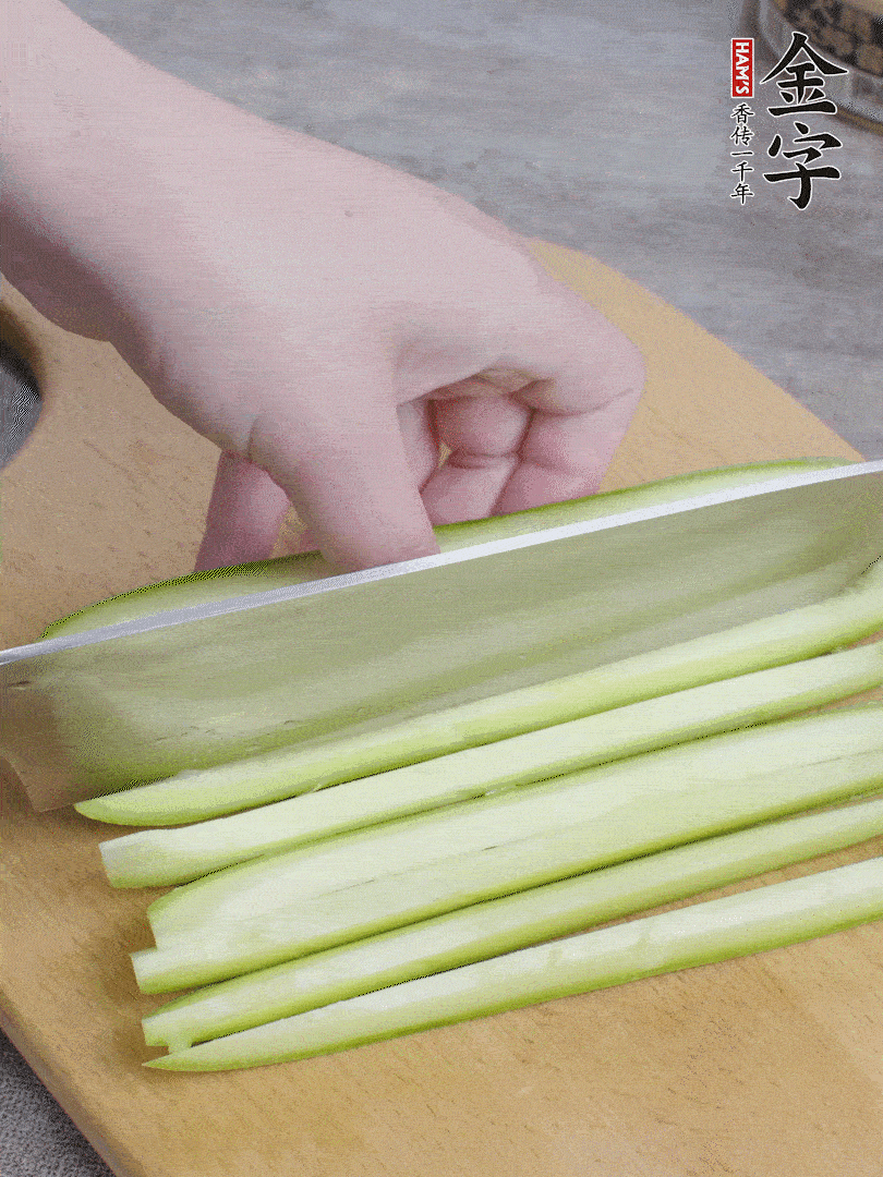 西葫蘆對(duì)半切，去瓤切條。