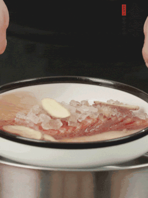 置于盤中，加冰糖100g、黃酒100g、水200g，上鍋蒸20分鐘。