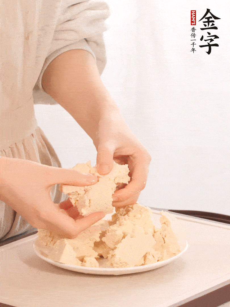 老豆腐用手掰成塊。